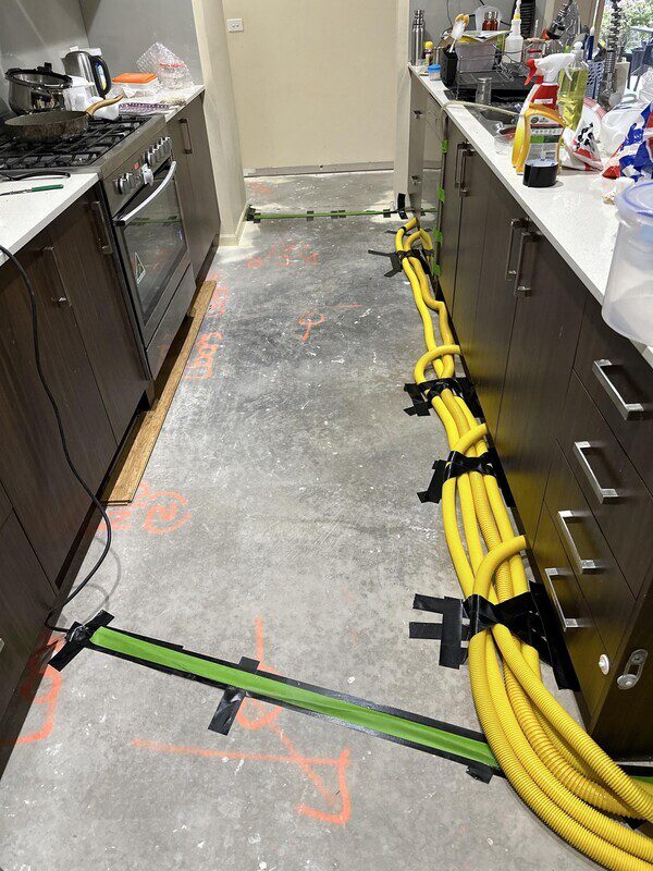 Structural drying to release moisture behind kickerboards